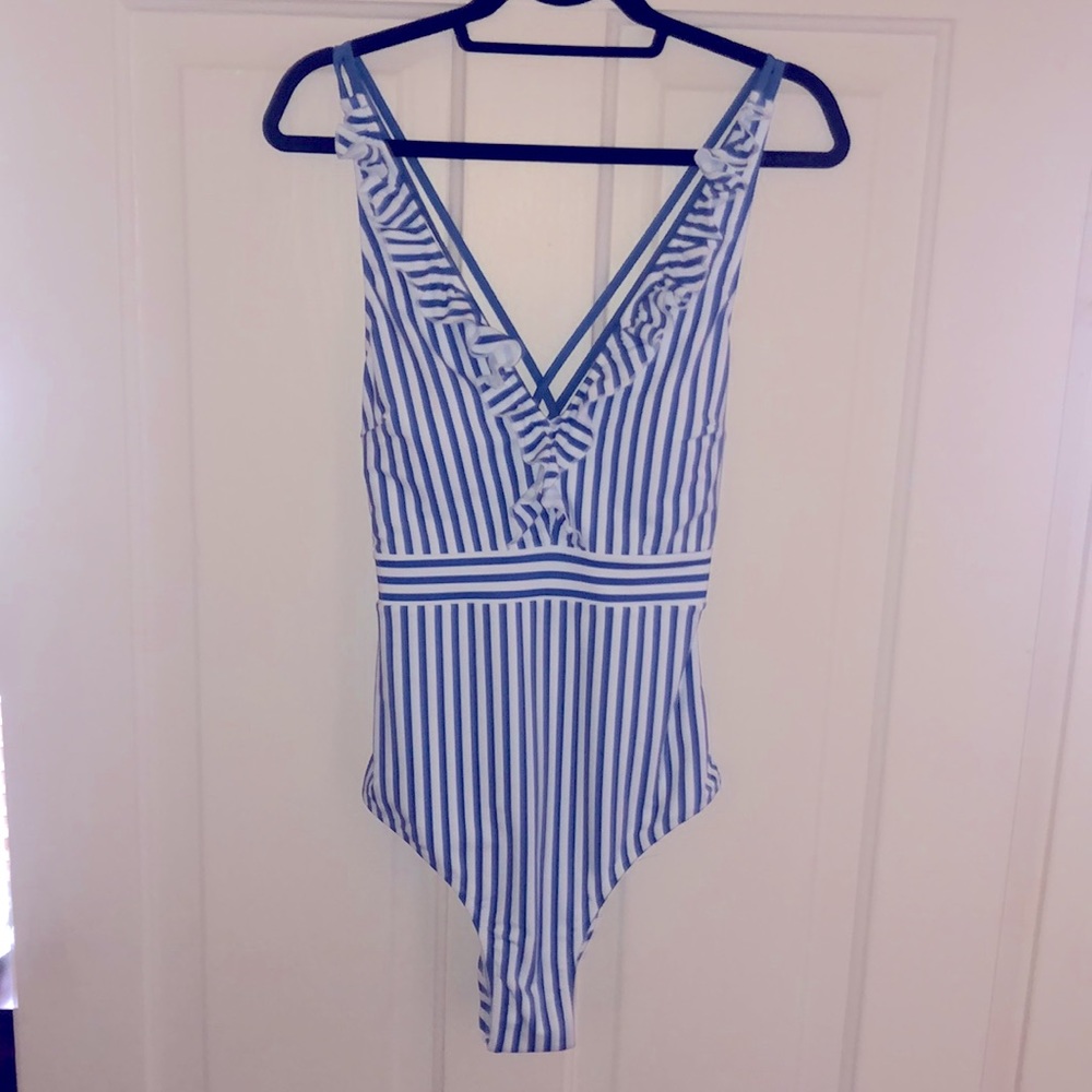 Flattering one piece swimsuit. Never worn! No tags
